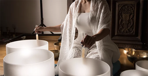 Woman using sound bowls