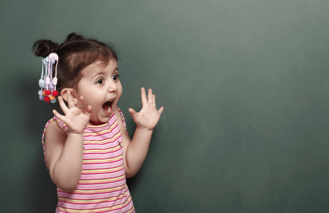 A little girl with surprise on her face.