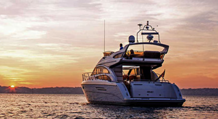 A yacht on the water at sunset